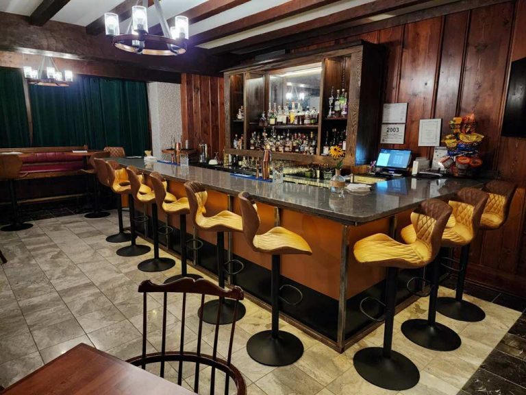 The Mather lounge with bar and table seating.